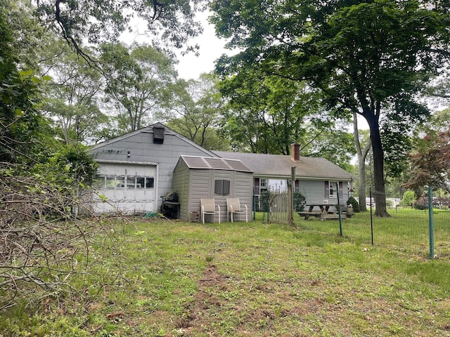 985 Ostrander Ave, Riverhead, NY 11901 - back of property with a chimney and a garage