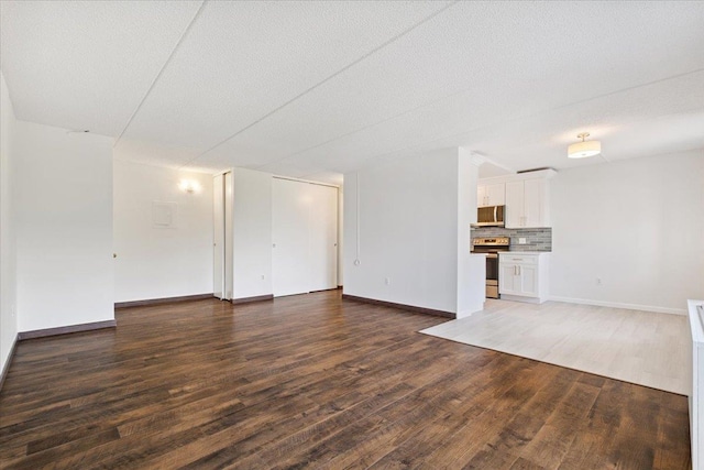 50 Columbus Ave Unit 611, Tuckahoe, NY 10707 - unfurnished living room featuring wood finished floors and a textured ceiling