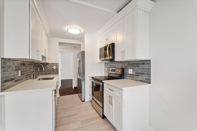 50 Columbus Ave Unit 611, Tuckahoe, NY 10707 - kitchen with appliances with stainless steel finishes, white cabinets, and backsplash