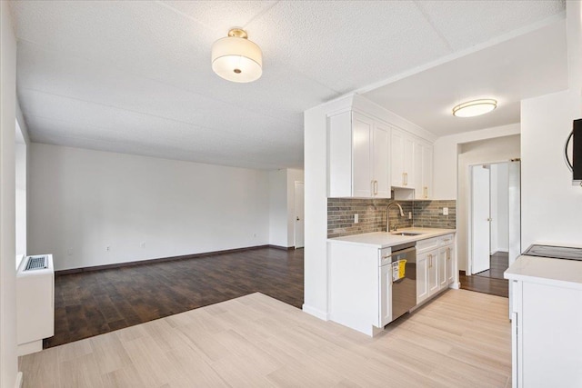 50 Columbus Ave Unit 611, Tuckahoe, NY 10707 - kitchen featuring stainless steel dishwasher, light countertops, white cabinetry, and open floor plan