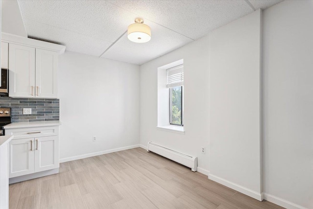 50 Columbus Ave Unit 611, Tuckahoe, NY 10707 - unfurnished dining area featuring baseboard heating and light wood-type flooring