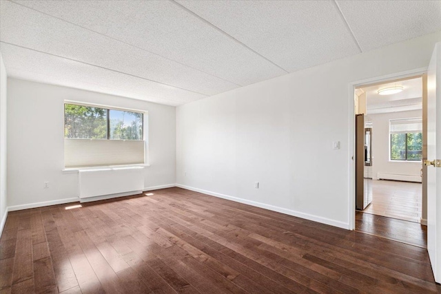 50 Columbus Ave Unit 611, Tuckahoe, NY 10707 - empty room with baseboard heating, dark wood finished floors, and a textured ceiling