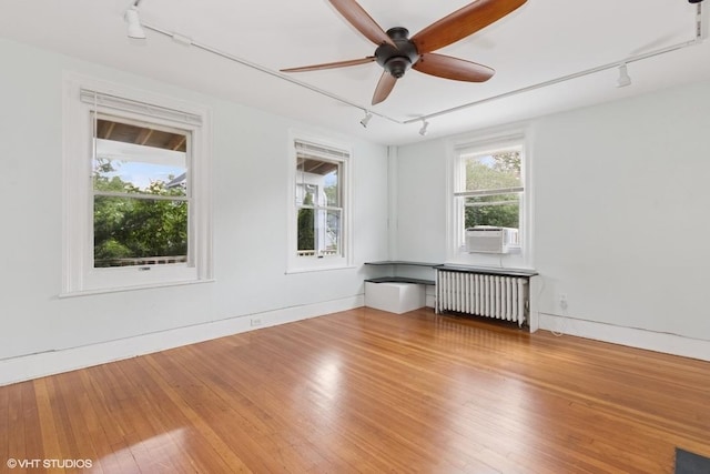 4 Dewindt St, Beacon, NY 12508 - spare room featuring rail lighting, radiator, and wood finished floors