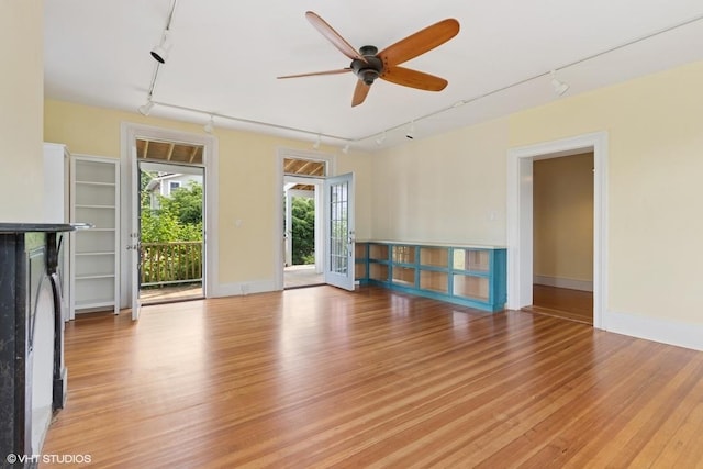 4 Dewindt St, Beacon, NY 12508 - unfurnished living room with rail lighting, ceiling fan, and light wood-style floors
