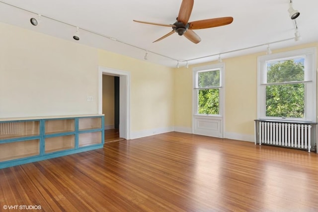 4 Dewindt St, Beacon, NY 12508 - empty room with track lighting, radiator heating unit, and ceiling fan