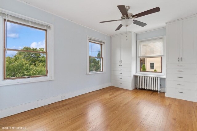 4 Dewindt St, Beacon, NY 12508 - unfurnished bedroom with radiator, light wood-style floors, and multiple windows