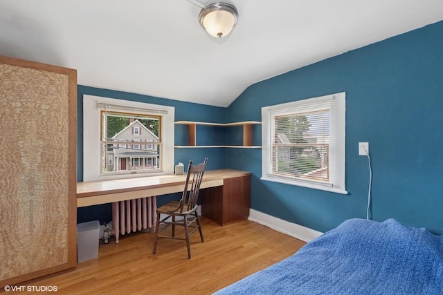 4 Dewindt St, Beacon, NY 12508 - bedroom with built in desk, vaulted ceiling, wood finished floors, and radiator heating unit
