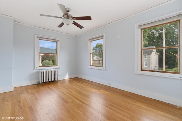 4 Dewindt St, Beacon, NY 12508 - empty room featuring radiator heating unit, healthy amount of natural light, light wood-style floors, and crown molding