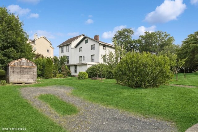 4 Dewindt St, Beacon, NY 12508 - view of front of property featuring a storage unit, a chimney, and a front yard