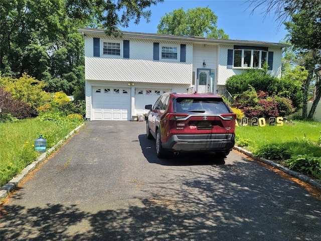 153 Cocoanut St, Brentwood, NY 11717 - split foyer home with asphalt driveway and a garage
