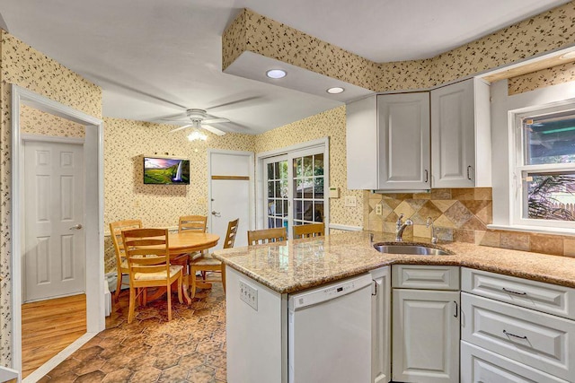 313 Pine St, Freeport, NY 11520 - kitchen with dishwasher, wallpapered walls, ceiling fan, recessed lighting, and light stone counters