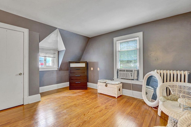 313 Pine St, Freeport, NY 11520 - living area featuring wood-type flooring, cooling unit, and lofted ceiling