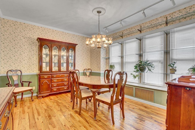 313 Pine St, Freeport, NY 11520 - dining area with wallpapered walls, a wainscoted wall, a chandelier, track lighting, and light wood-type flooring