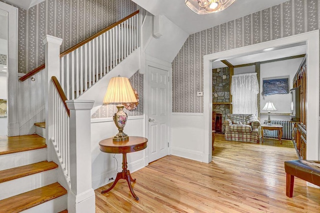 313 Pine St, Freeport, NY 11520 - stairway with wallpapered walls, wood finished floors, radiator, and wainscoting