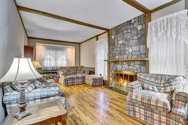 313 Pine St, Freeport, NY 11520 - living room with wood finished floors, beam ceiling, and a stone fireplace