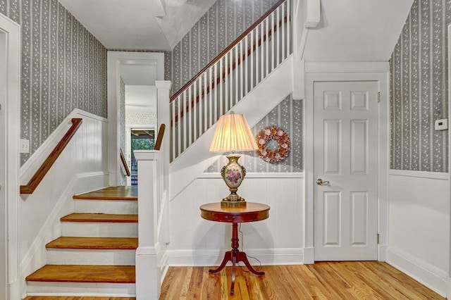 313 Pine St, Freeport, NY 11520 - stairs featuring wallpapered walls, wood finished floors, and a wainscoted wall