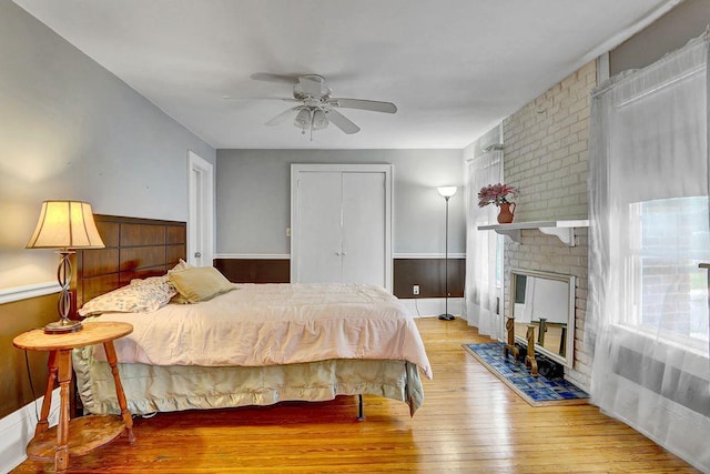 313 Pine St, Freeport, NY 11520 - bedroom with wood-type flooring, a fireplace, a closet, and ceiling fan