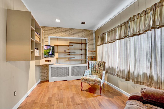 313 Pine St, Freeport, NY 11520 - sitting room with brick wall and wood finished floors