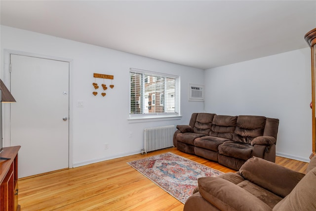 71-12 260th St Fl H 1St, Glen Oaks, NY 11004 - living room with radiator, an AC wall unit, and wood finished floors