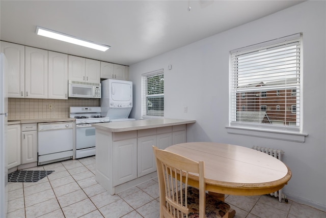 71-12 260th St Fl H 1St, Glen Oaks, NY 11004 - kitchen featuring white appliances, stacked washer and clothes dryer, white cabinets, and light countertops