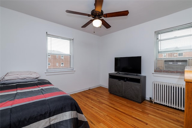 71-12 260th St Fl H 1St, Glen Oaks, NY 11004 - bedroom with radiator, light wood finished floors, and a ceiling fan