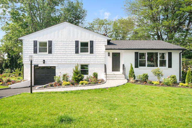 2 Danby Pl, Yonkers, NY 10710 - tri-level home featuring a garage, driveway, a front yard, and brick siding