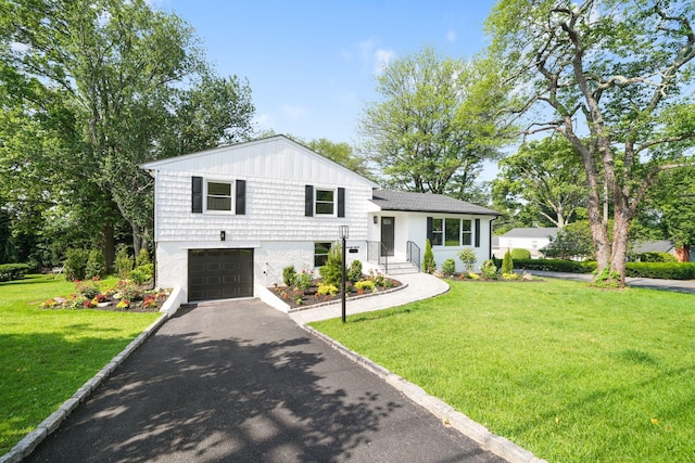 2 Danby Pl, Yonkers, NY 10710 - tri-level home featuring a garage, driveway, and a front lawn