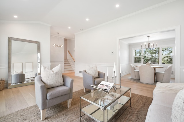 2 Danby Pl, Yonkers, NY 10710 - living area featuring a chandelier, light wood-type flooring, a decorative wall, wainscoting, and crown molding