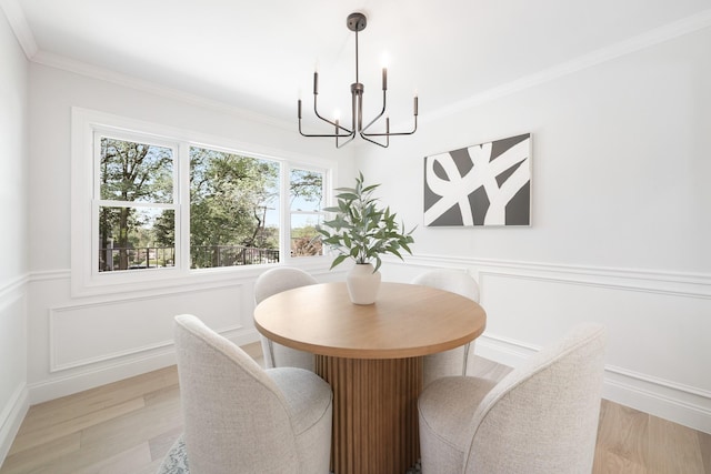 2 Danby Pl, Yonkers, NY 10710 - dining room featuring a chandelier, light wood-type flooring, crown molding, wainscoting, and a decorative wall