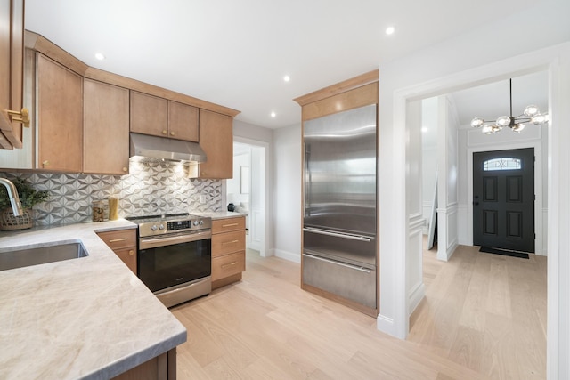 2 Danby Pl, Yonkers, NY 10710 - kitchen featuring stainless steel appliances, under cabinet range hood, a chandelier, light wood finished floors, and recessed lighting