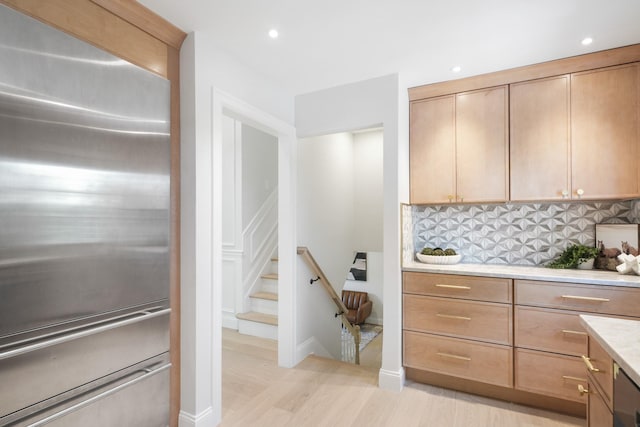 2 Danby Pl, Yonkers, NY 10710 - kitchen with high end refrigerator, light countertops, tasteful backsplash, recessed lighting, and light wood finished floors