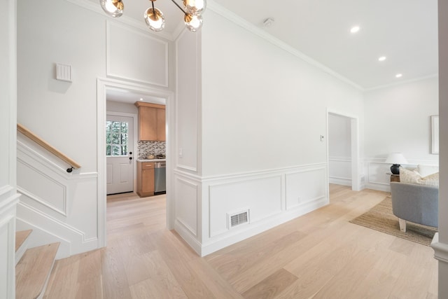 2 Danby Pl, Yonkers, NY 10710 - hall with crown molding, a decorative wall, light wood finished floors, stairs, and a chandelier