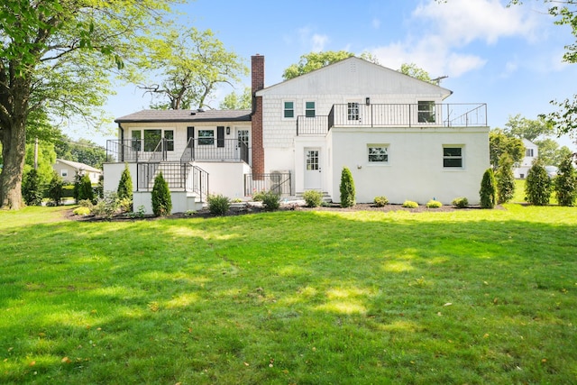 2 Danby Pl, Yonkers, NY 10710 - back of property with a balcony, a lawn, a chimney, and stairway