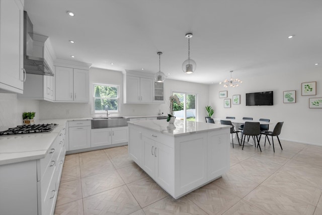 94 Fairview Ave, Great Neck, NY 11023 - kitchen featuring stainless steel gas cooktop, wall chimney range hood, healthy amount of natural light, a chandelier, and recessed lighting