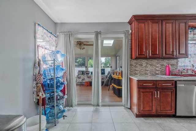 694 Koelbel Ct, Baldwin, NY 11510 - kitchen with reddish brown cabinets, light countertops, tasteful backsplash, and light tile patterned floors
