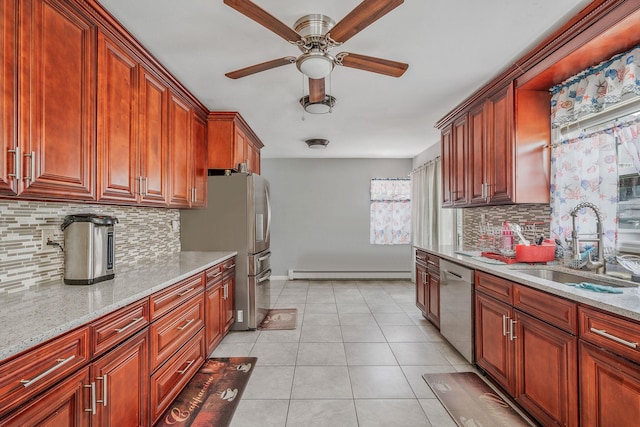 694 Koelbel Ct, Baldwin, NY 11510 - kitchen with appliances with stainless steel finishes, a baseboard radiator, backsplash, a ceiling fan, and light stone counters