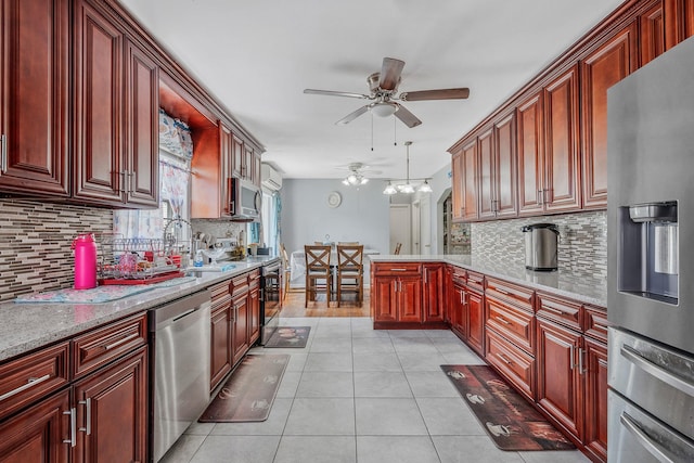 694 Koelbel Ct, Baldwin, NY 11510 - kitchen with stainless steel appliances, ceiling fan, a peninsula, and tasteful backsplash