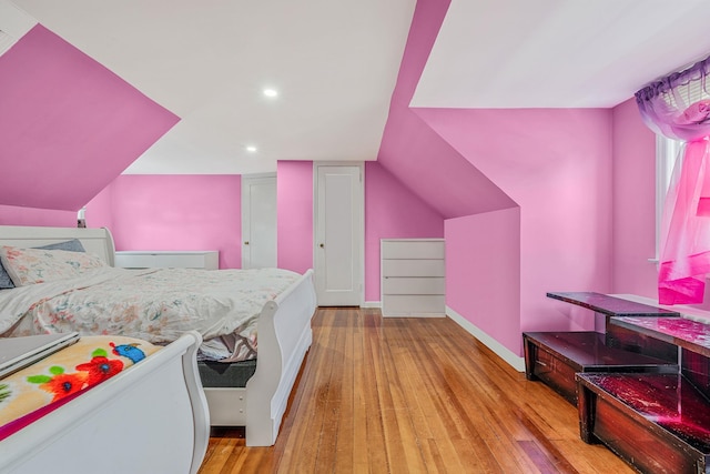 694 Koelbel Ct, Baldwin, NY 11510 - bedroom with wood finished floors and recessed lighting