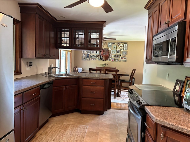 266 Adirondack Dr, Selden, NY 11784 - kitchen with appliances with stainless steel finishes, a ceiling fan, a peninsula, and light tile patterned flooring