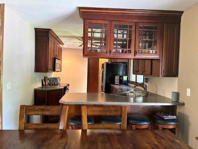 266 Adirondack Dr, Selden, NY 11784 - kitchen with stainless steel appliances, glass insert cabinets, a peninsula, and a breakfast bar area