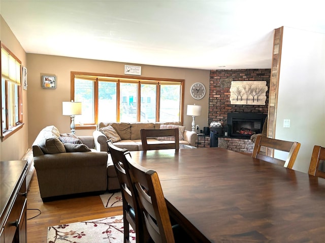 266 Adirondack Dr, Selden, NY 11784 - dining area with a brick fireplace and light wood finished floors