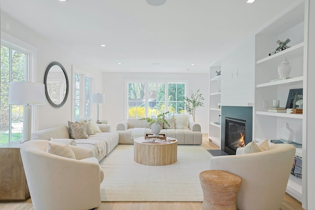 1 Devoe Rd, Armonk, NY 10504 - living room with a fireplace with flush hearth, healthy amount of natural light, built in features, light wood-style floors, and recessed lighting