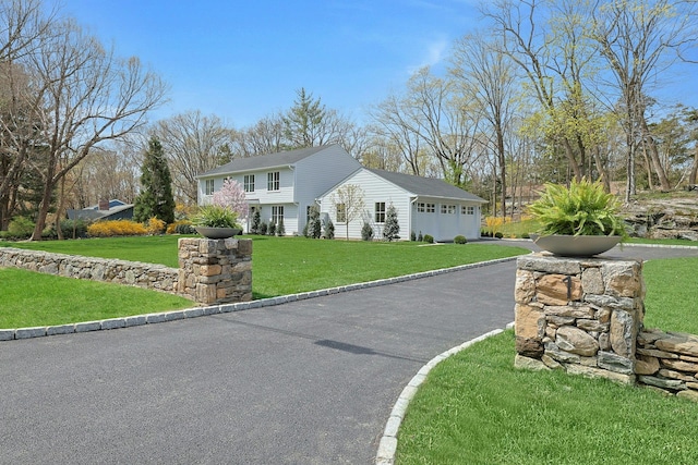 1 Devoe Rd, Armonk, NY 10504 - colonial home with an attached garage, asphalt driveway, and a front yard