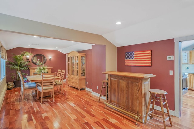 6 Sunrise Pl, Farmingville, NY 11738 - dining room with vaulted ceiling, light wood-type flooring, a bar, and recessed lighting