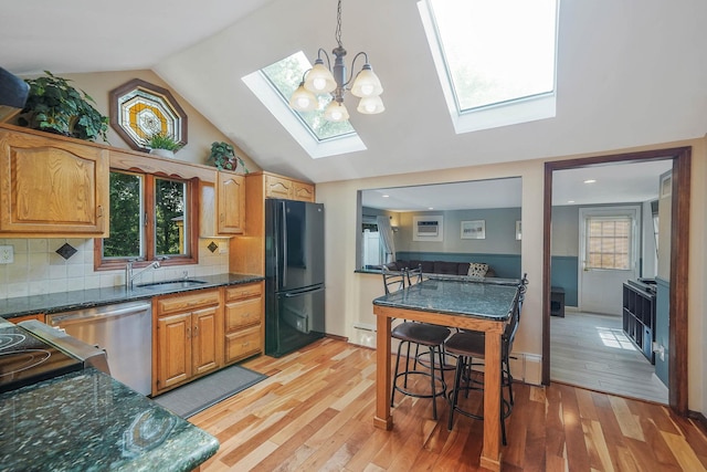 6 Sunrise Pl, Farmingville, NY 11738 - kitchen featuring a skylight, freestanding refrigerator, dishwasher, light wood-type flooring, and tasteful backsplash
