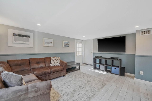 6 Sunrise Pl, Farmingville, NY 11738 - living room featuring a wall unit AC, wood finished floors, and recessed lighting