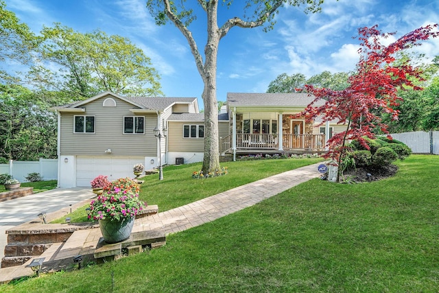 6 Sunrise Pl, Farmingville, NY 11738 - back of house featuring concrete driveway, an attached garage, and covered porch
