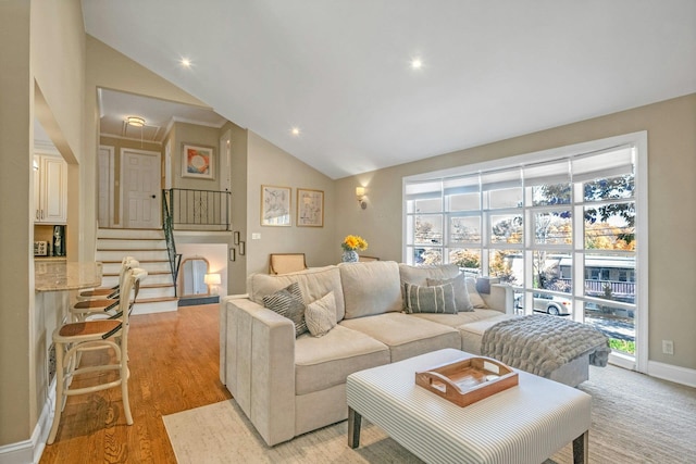92 Wiltshire Rd, Scarsdale, NY 10583 - living room featuring plenty of natural light, light wood-type flooring, stairway, high vaulted ceiling, and recessed lighting