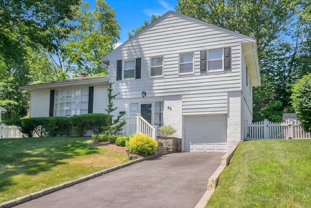 92 Wiltshire Rd, Scarsdale, NY 10583 - tri-level home featuring asphalt driveway, an attached garage, and brick siding