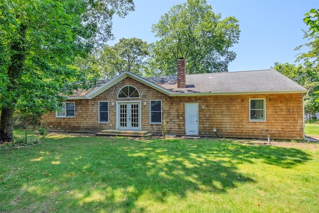 82A Union Ave, Center Moriches, NY 11934 - rear view of property with french doors, a chimney, and a lawn